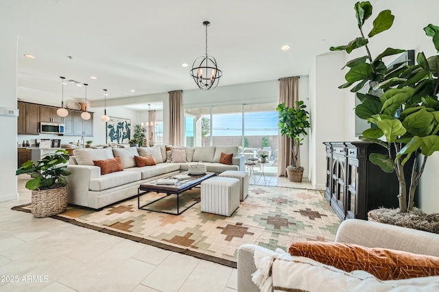 living area featuring light tile patterned floors, a notable chandelier, and recessed lighting