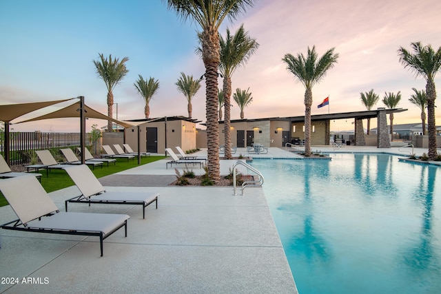 community pool featuring a patio area and fence