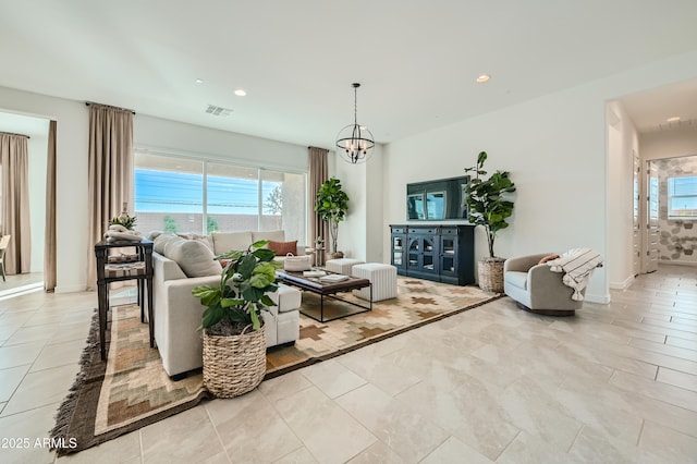 living area featuring a chandelier, a wealth of natural light, and recessed lighting