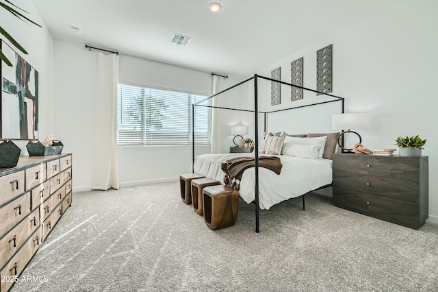 carpeted bedroom featuring visible vents and baseboards