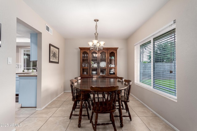 15424 N 52nd Pl, Scottsdale, AZ 85254 - dining room with a chandelier, light tile patterned floors, and baseboards