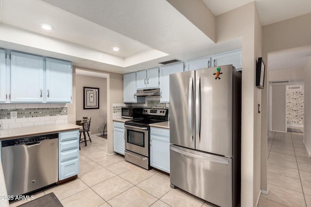15424 N 52nd Pl, Scottsdale, AZ 85254 - kitchen with stainless steel appliances, light countertops, tasteful backsplash, light tile patterned flooring, and recessed lighting