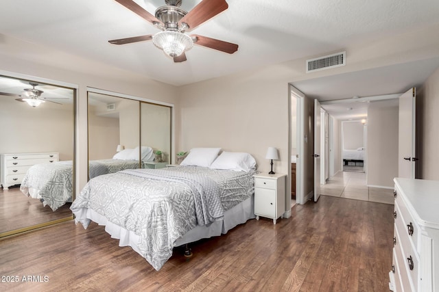 15424 N 52nd Pl, Scottsdale, AZ 85254 - bedroom featuring two closets, wood finished floors, and ceiling fan