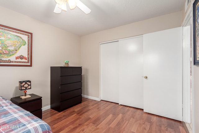 15424 N 52nd Pl, Scottsdale, AZ 85254 - bedroom featuring wood finished floors, a closet, a ceiling fan, and baseboards