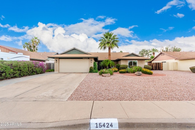 15424 N 52nd Pl, Scottsdale, AZ 85254 - single story home featuring a garage, concrete driveway, brick siding, and fence