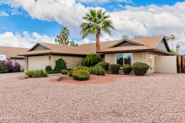 15424 N 52nd Pl, Scottsdale, AZ 85254 - single story home featuring concrete driveway, an attached garage, brick siding, fence, and a shingled roof