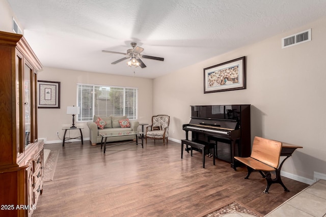 15424 N 52nd Pl, Scottsdale, AZ 85254 - sitting room featuring ceiling fan, wood finished floors, baseboards, and a textured ceiling