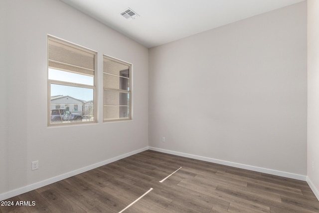 unfurnished room featuring dark wood-type flooring