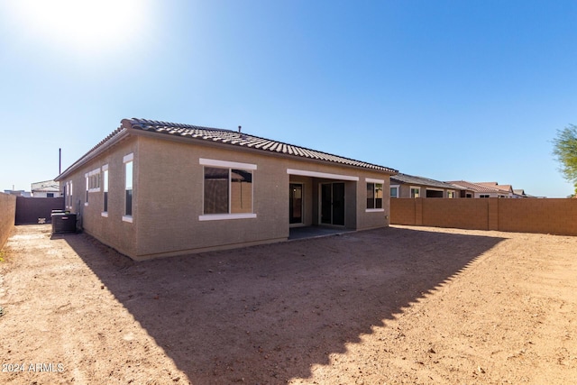 rear view of house featuring central air condition unit