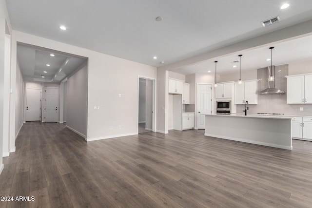 unfurnished living room featuring dark hardwood / wood-style flooring and sink