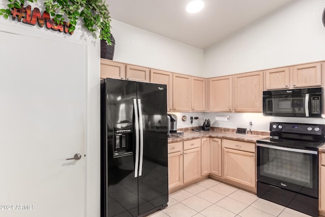 kitchen featuring a towering ceiling, light tile patterned floors, light brown cabinets, and black appliances