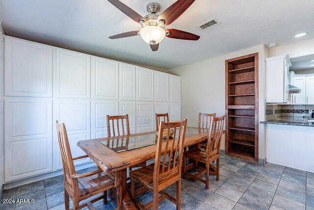 dining area featuring built in features and ceiling fan