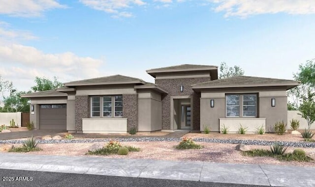 10024 S 38th Ln, Laveen, AZ 85339 - prairie-style house featuring a garage, concrete driveway, stucco siding, and brick siding