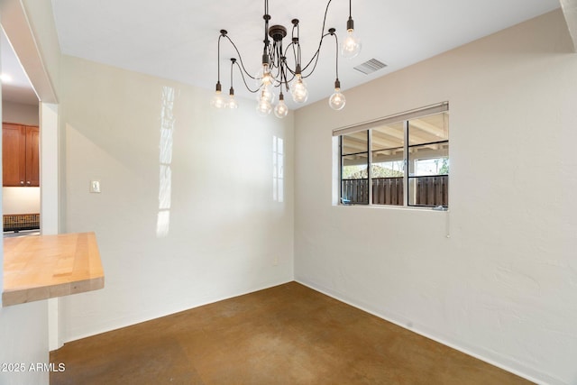 unfurnished dining area with a notable chandelier