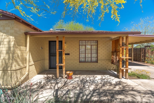 doorway to property featuring a carport