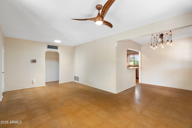 unfurnished room with ceiling fan with notable chandelier and concrete flooring