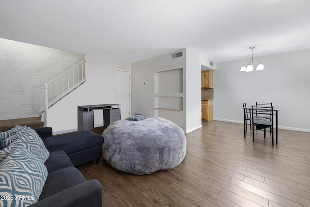 living room featuring a chandelier and hardwood / wood-style flooring