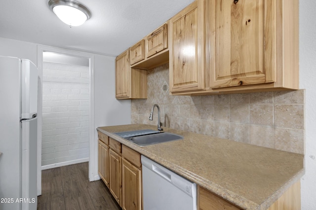 kitchen featuring light brown cabinetry, dark wood-type flooring, sink, and white appliances