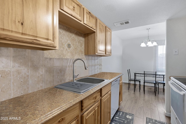 kitchen featuring white appliances, decorative light fixtures, light brown cabinetry, sink, and light hardwood / wood-style flooring