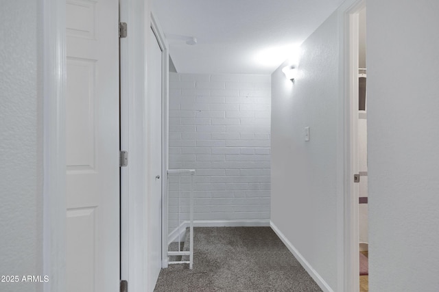 hall featuring dark colored carpet