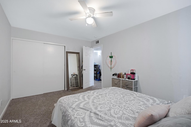 carpeted bedroom with ceiling fan and a closet