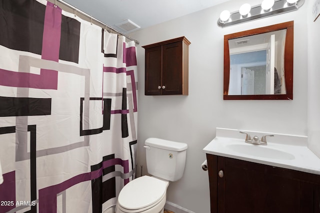 bathroom with toilet, vanity, and walk in shower