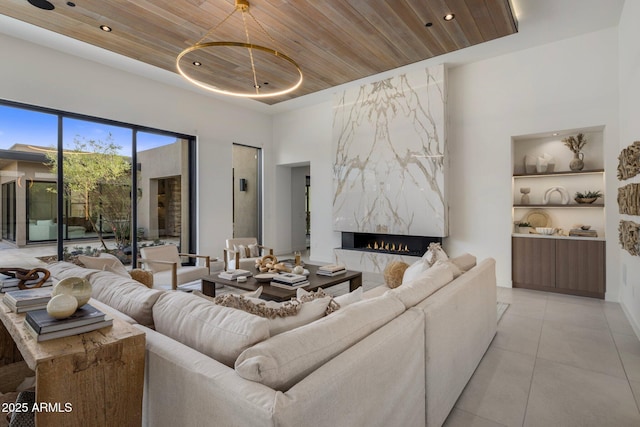 24863 N 103rd Way, Scottsdale, AZ 85255 - living area with wooden ceiling, a premium fireplace, light tile patterned floors, and recessed lighting