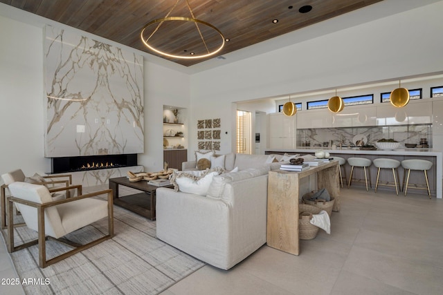 24863 N 103rd Way, Scottsdale, AZ 85255 - living room featuring wood ceiling, a fireplace, light tile patterned flooring, and a towering ceiling