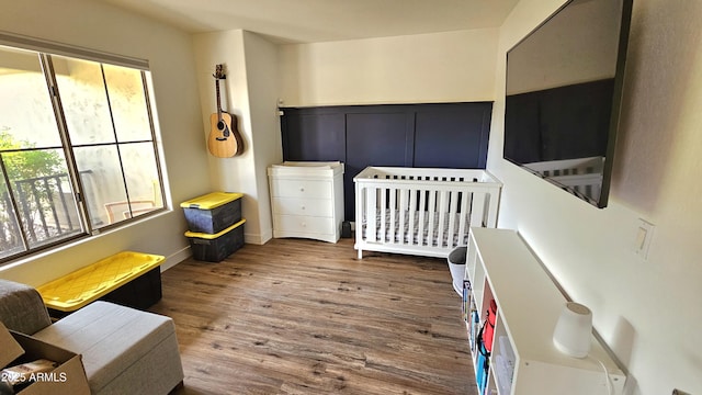 3002 W Caravaggio Ln, Phoenix, AZ 85086 - bedroom featuring wood finished floors and a crib