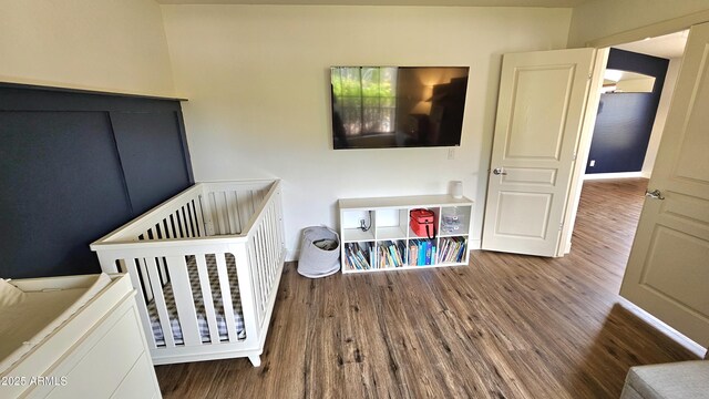 3002 W Caravaggio Ln, Phoenix, AZ 85086 - bedroom featuring wood finished floors, baseboards, and a crib