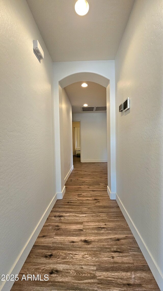 3002 W Caravaggio Ln, Phoenix, AZ 85086 - hall with arched walkways, dark wood finished floors, baseboards, and recessed lighting