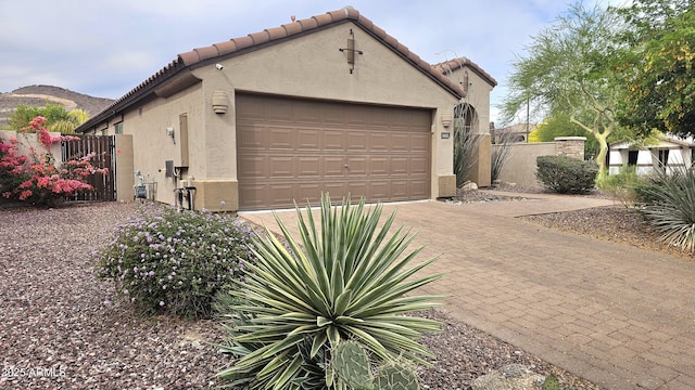 3002 W Caravaggio Ln, Phoenix, AZ 85086 - view of side of home featuring stucco siding, a gate, a tiled roof, and fence