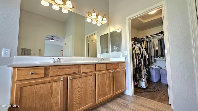 3002 W Caravaggio Ln, Phoenix, AZ 85086 - full bath featuring wood finished floors, double vanity, a walk in closet, and ceiling fan