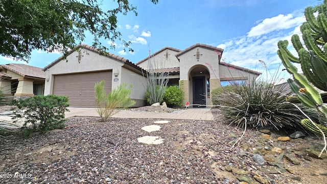 3002 W Caravaggio Ln, Phoenix, AZ 85086 - mediterranean / spanish-style home featuring stucco siding, a tiled roof, driveway, and an attached garage