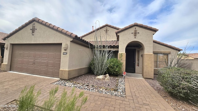 3002 W Caravaggio Ln, Phoenix, AZ 85086 - mediterranean / spanish-style home with a tile roof, stucco siding, a garage, and decorative driveway