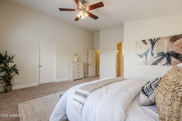 bedroom with ceiling fan, vaulted ceiling, and light carpet