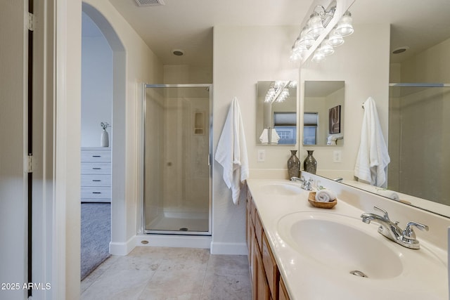 bathroom featuring walk in shower, tile patterned flooring, and vanity