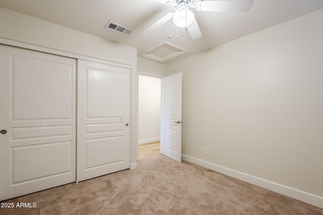 unfurnished bedroom with a closet, ceiling fan, and light colored carpet