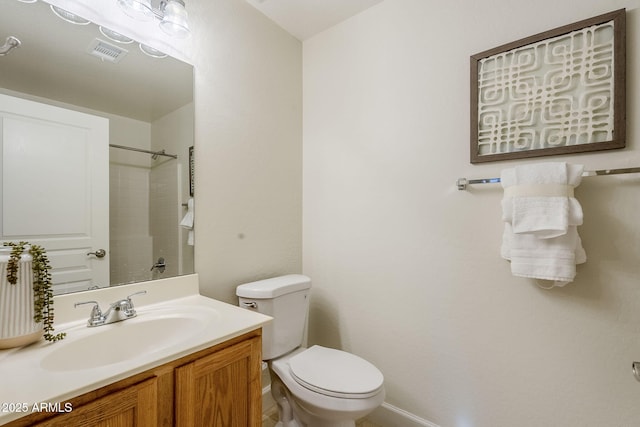 bathroom featuring toilet and vanity