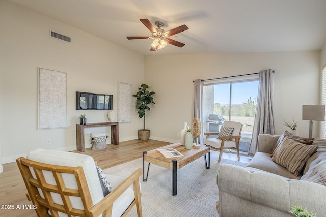 living room featuring lofted ceiling, ceiling fan, and light hardwood / wood-style flooring