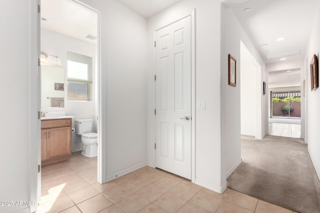 corridor featuring light tile patterned flooring