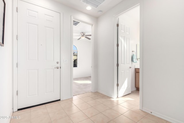 tiled foyer entrance with ceiling fan