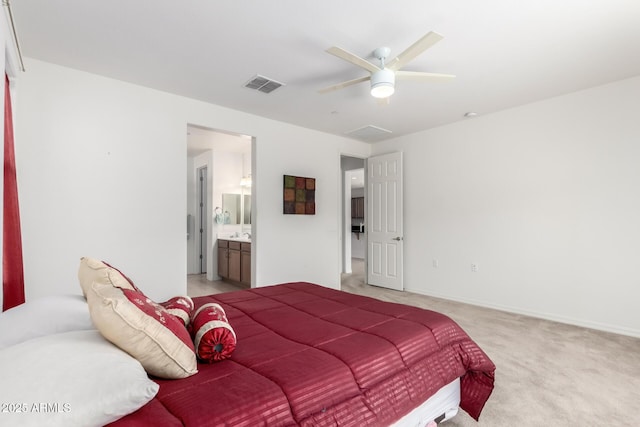 carpeted bedroom with connected bathroom and ceiling fan