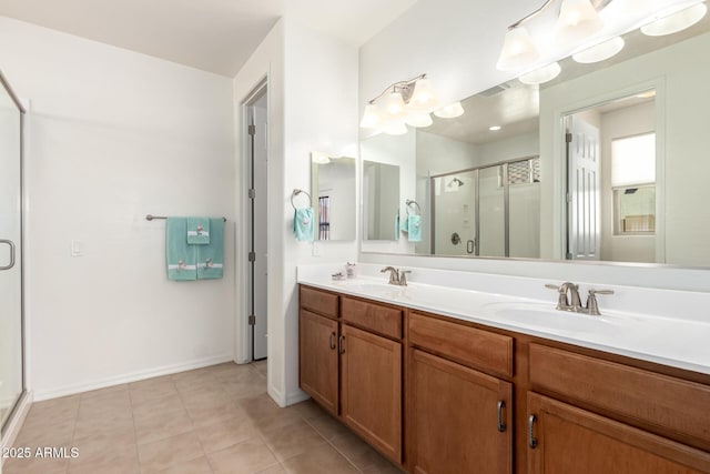 bathroom featuring vanity, a shower with shower door, and tile patterned flooring