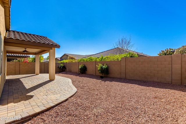 view of yard featuring ceiling fan and a patio area