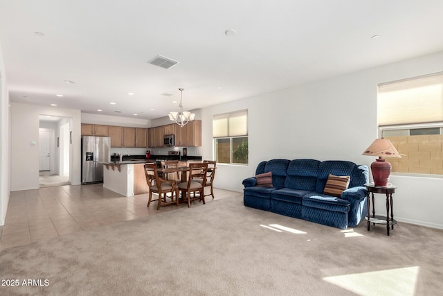 carpeted living room featuring a chandelier and sink