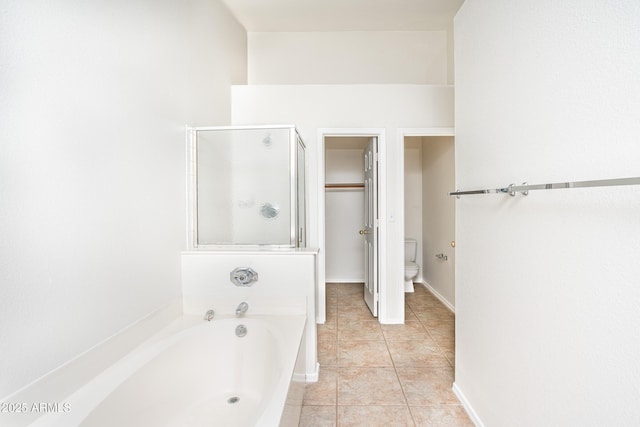 bathroom with a bath, tile patterned flooring, a stall shower, and toilet