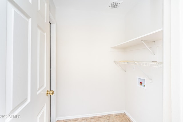 clothes washing area with laundry area, baseboards, visible vents, and washer hookup