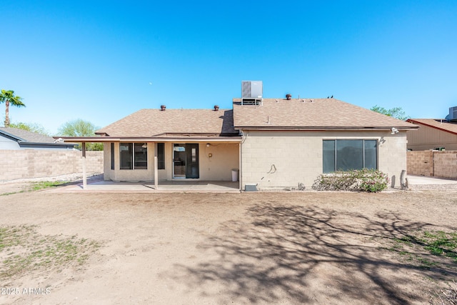 back of house with central AC, a shingled roof, a patio, and fence