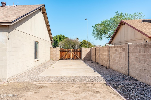 exterior space with a patio area, a gate, and fence